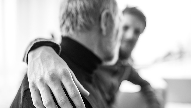 son places hand on fathers shoulder