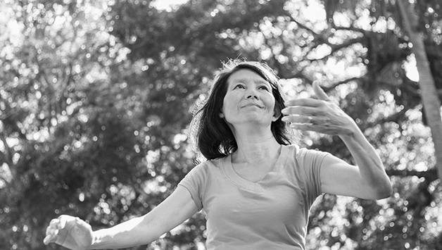 senior woman doing tai chi outside