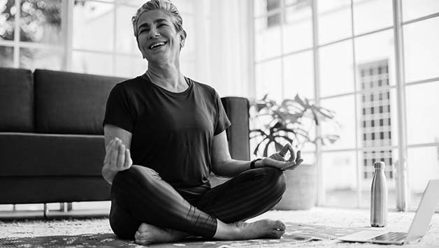 senior woman doing yoga on the floor