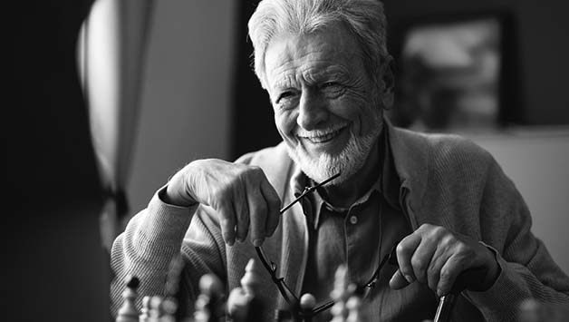 senior man playing chess