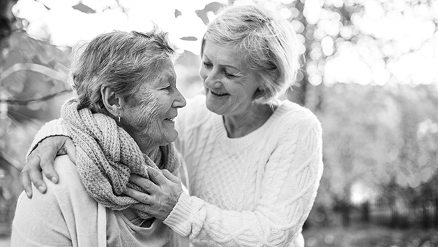 woman and her adult daughter hugging