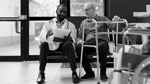 doctor consulting a patient with a walker