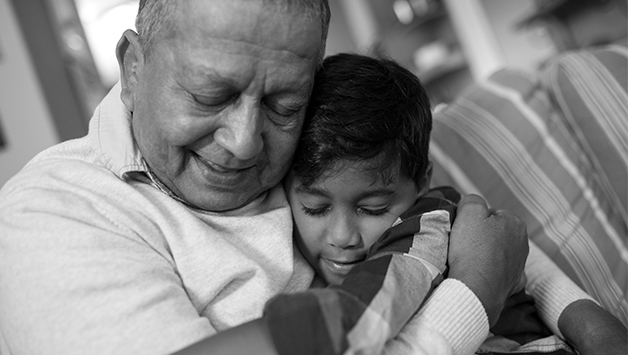 grandfather hugging grandson