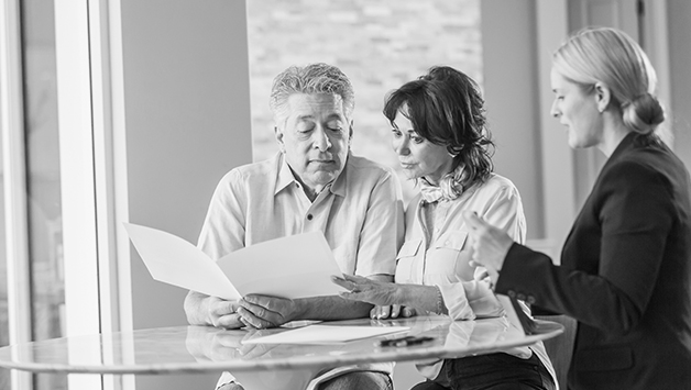 senior couple with agent at preplanning appointment
