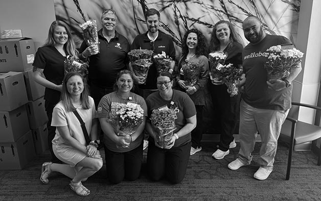 Wellabe staff delivering Blooming with Hope flowers