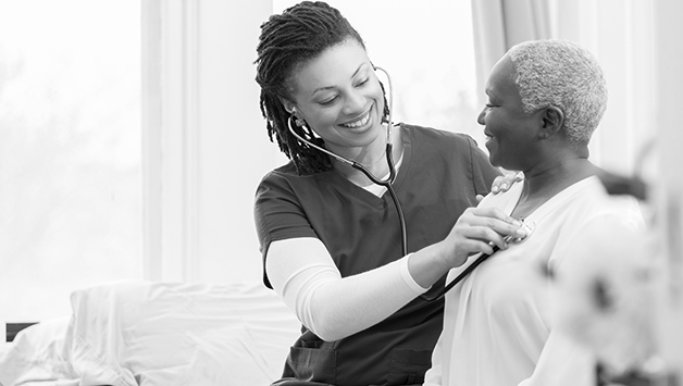 nurse helps senior woman in hospital