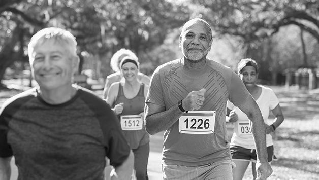 senior man running a race