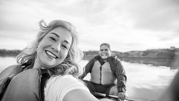 senior couple paddling in canoe