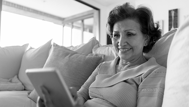 senior woman reading on ipad