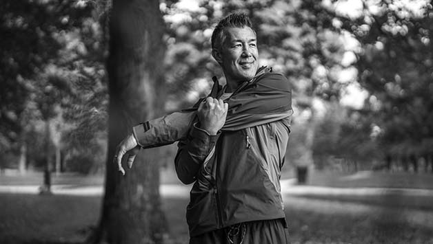 middle aged man stretching outside